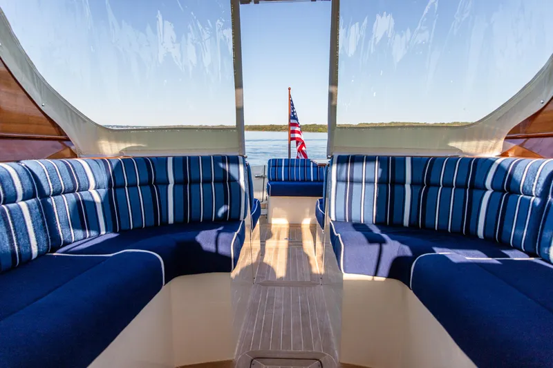 Leodes Yacht Photos Pics Interior of 2022 Hinckley Picnic Boat 34 S with striped seating and American flag.