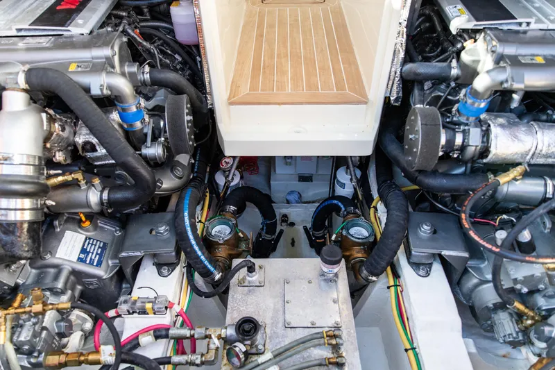 Leodes Yacht Photos Pics Engine compartment of a 2022 Hinckley Picnic Boat 34 S, showcasing dual engines and mechanical components.