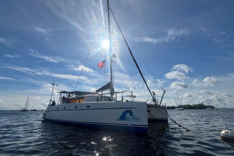Sea Glass Yacht Photos Pics Fountaine Pajot Belize 43 catamaran, 2000 model, sailing under a bright blue sky.