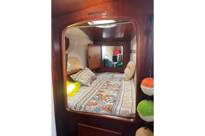 Sea Glass Yacht Photos Pics Cozy cabin interior of 2000 Fountaine Pajot Belize 43 with colorful bedding.