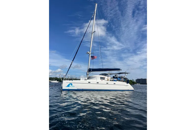 Sea Glass Yacht Photos Pics Sailing catamaran Fountaine Pajot Belize 43, 2000 model, on calm waters under blue sky.
