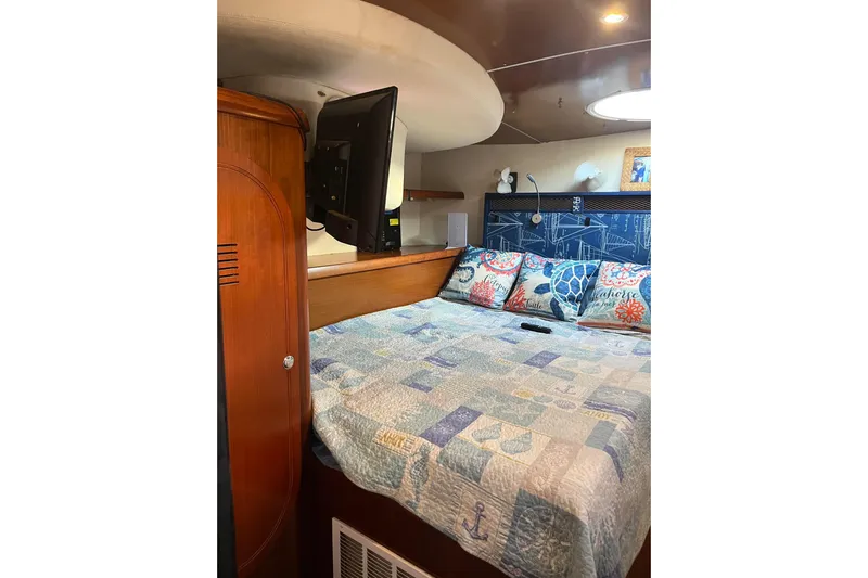 Sea Glass Yacht Photos Pics Cozy bedroom interior of 2000 Fountaine Pajot Belize 43 catamaran with nautical-themed decor.