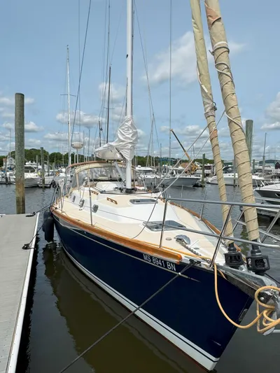 Side Aye Yacht Photos Pics 2009 Tartan 3400 sailboat docked at marina under blue sky.