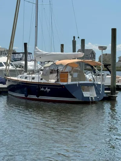 Side Aye Yacht Photos Pics 2009 Tartan 3400 sailboat docked in a marina under a clear blue sky.