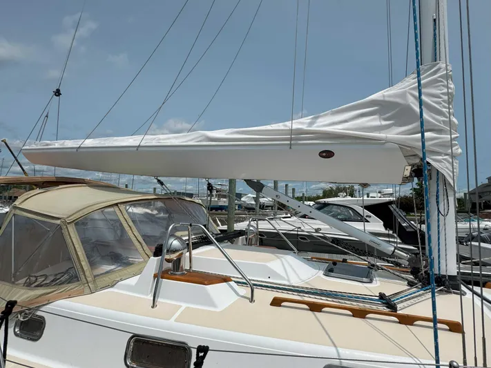 Side Aye Yacht Photos Pics Sailboat Tartan 3400, 2009 model, docked with covered mainsail and beige canopy.