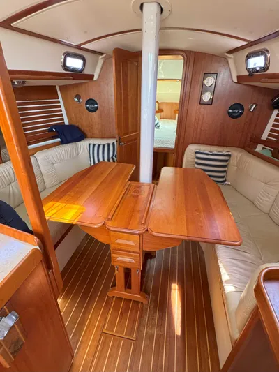 Side Aye Yacht Photos Pics Interior of a 2009 Tartan 3400 sailboat with wooden dining area and seating.