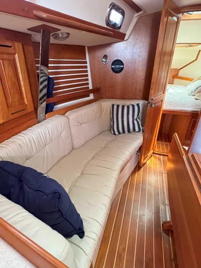 Side Aye Yacht Photos Pics Interior of 2009 Tartan 3400 sailboat with cozy seating and wooden finishes.