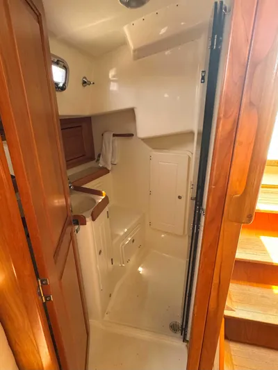 Side Aye Yacht Photos Pics 2009 Tartan 3400 yacht interior bathroom with wooden accents and compact design.