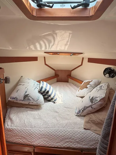 Side Aye Yacht Photos Pics Cozy cabin interior of 2009 Tartan 3400 sailboat with plush bedding and natural light.
