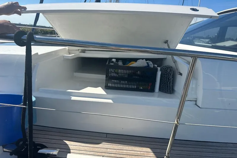 Three Bears Yacht Photos Pics Open storage compartment on 2012 Fairline Targa 58 yacht with cleaning supplies.