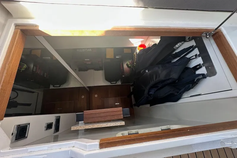 Three Bears Yacht Photos Pics Storage compartment on 2012 Fairline Targa 58 yacht with life jackets and equipment.