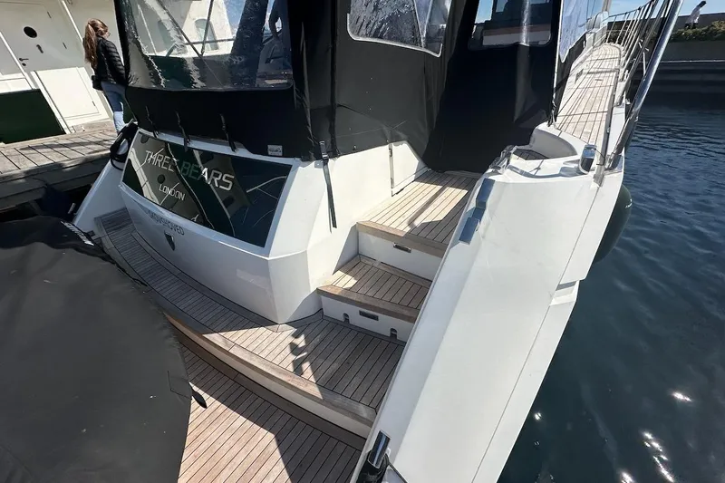 Three Bears Yacht Photos Pics Fairline Targa 58 yacht, 2012 model, docked with wooden steps and black canopy.