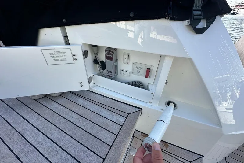 Three Bears Yacht Photos Pics 2012 Fairline Targa 58 yacht deck with open storage compartment and marine equipment.