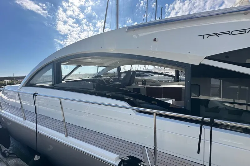 Three Bears Yacht Photos Pics 2012 Fairline Targa 58 yacht with sleek design, docked under a bright blue sky.