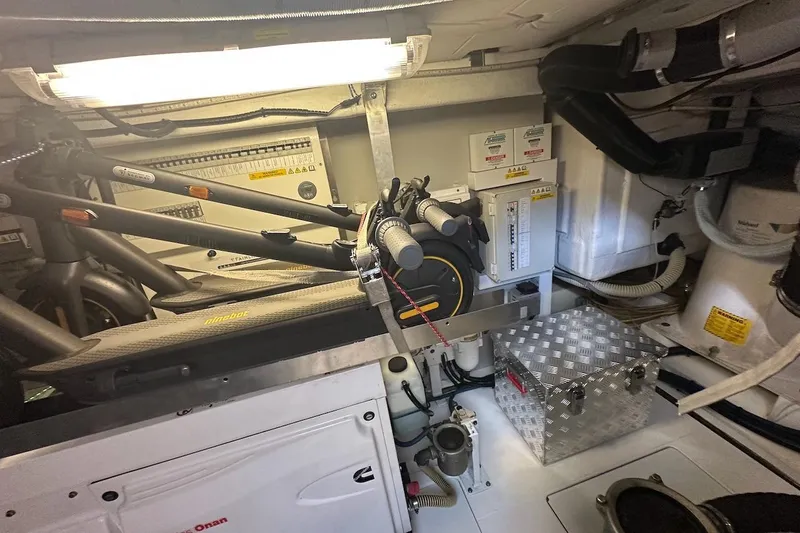 Three Bears Yacht Photos Pics Engine room of 2012 Fairline Targa 58 yacht, featuring mechanical components and storage.