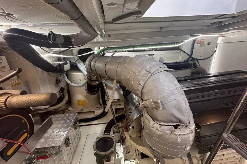 Three Bears Yacht Photos Pics Engine room of 2012 Fairline Targa 58 yacht, showcasing mechanical components and insulation.