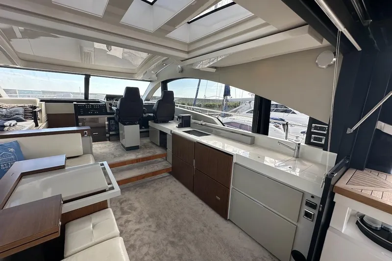 Three Bears Yacht Photos Pics Luxurious interior of 2012 Fairline Targa 58 yacht with modern helm and seating area.