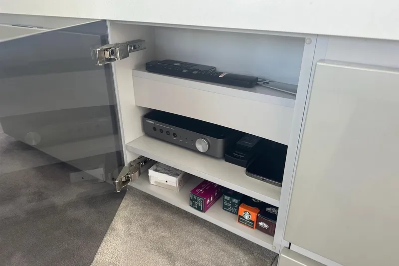 Three Bears Yacht Photos Pics Open cabinet with electronics and coffee pods on a Fairline Targa 58 yacht, 2012 model.