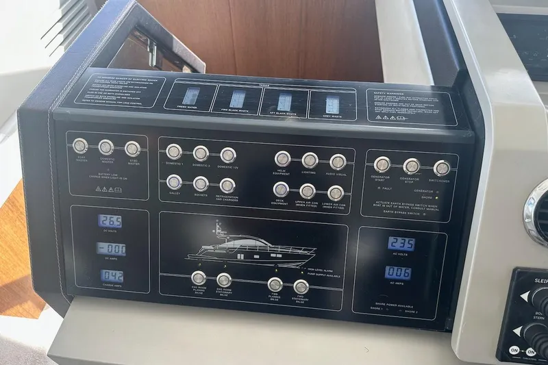 Three Bears Yacht Photos Pics Control panel of a 2012 Fairline Targa 58 yacht, featuring various switches and displays.