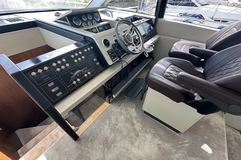 Three Bears Yacht Photos Pics Interior cockpit of 2012 Fairline Targa 58 yacht with modern controls and leather seating.