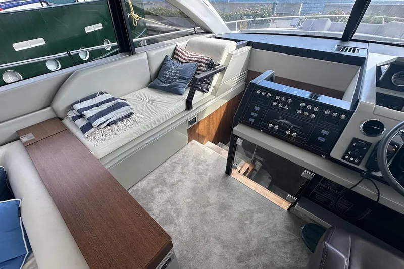 Three Bears Yacht Photos Pics Interior of 2012 Fairline Targa 58 yacht with modern seating and control panel.