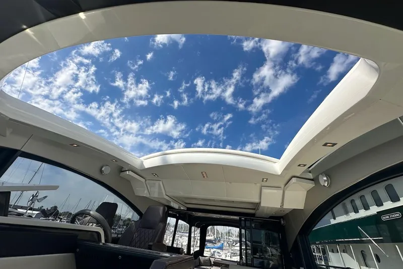Three Bears Yacht Photos Pics Interior view of 2012 Fairline Targa 58 yacht with open sunroof and blue sky.