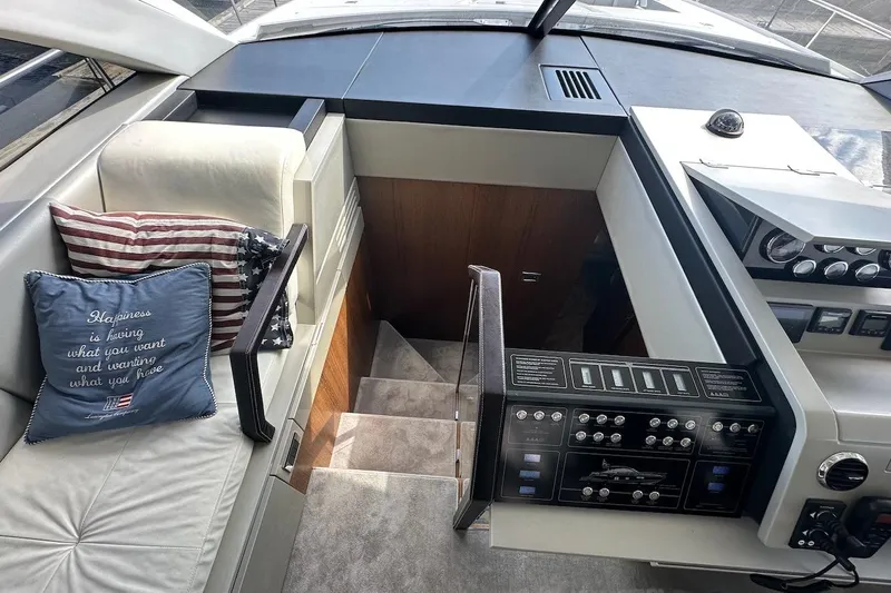 Three Bears Yacht Photos Pics Interior of 2012 Fairline Targa 58 yacht with control panel and cushioned seating.