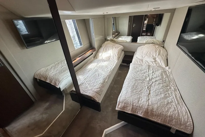 Three Bears Yacht Photos Pics Twin cabin interior of 2012 Fairline Targa 58 yacht with modern decor and TV.