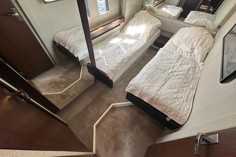 Three Bears Yacht Photos Pics Interior of 2012 Fairline Targa 58 yacht with twin beds and modern decor.