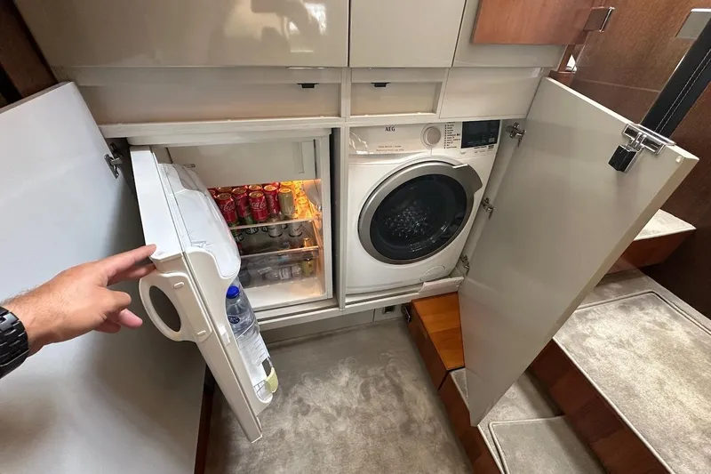 Three Bears Yacht Photos Pics Compact laundry and fridge area on 2012 Fairline Targa 58 yacht.