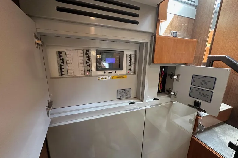 Three Bears Yacht Photos Pics Electrical control panel inside 2012 Fairline Targa 58 yacht, featuring circuit breakers and display.