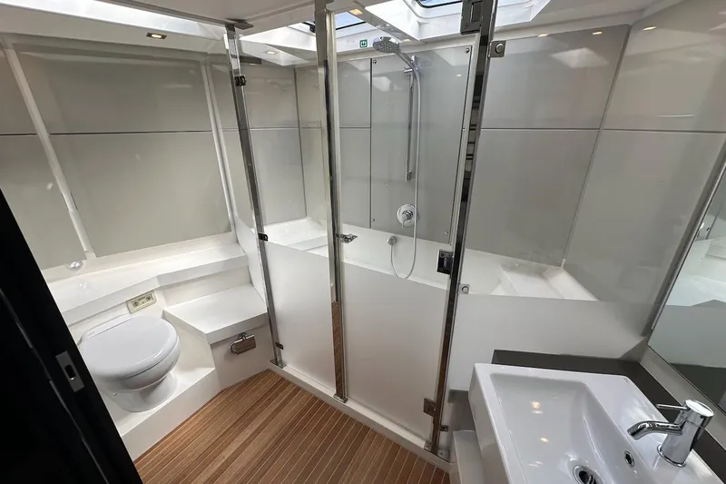 Three Bears Yacht Photos Pics Luxurious bathroom in 2012 Fairline Targa 58 yacht with modern fixtures and wooden flooring.