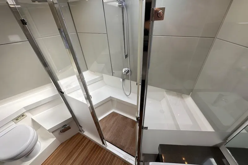 Three Bears Yacht Photos Pics Luxurious bathroom in 2012 Fairline Targa 58 yacht with modern shower and wooden flooring.