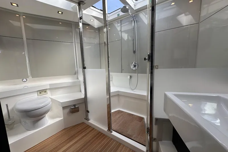 Three Bears Yacht Photos Pics Luxurious bathroom in 2012 Fairline Targa 58 yacht with modern fixtures and wooden flooring.