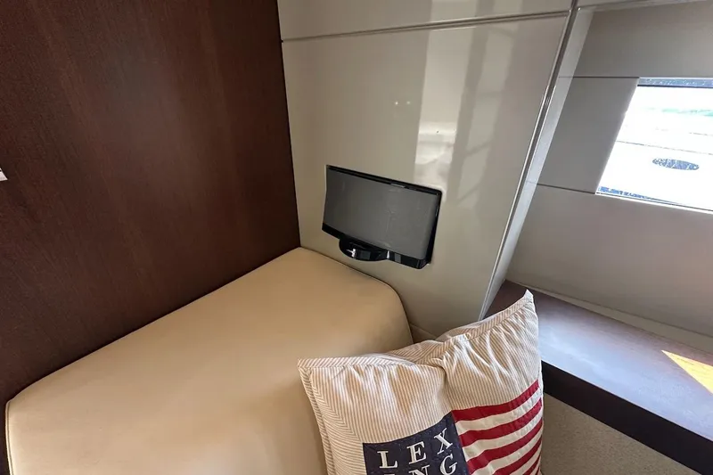 Three Bears Yacht Photos Pics Interior of 2012 Fairline Targa 58 yacht with bed, pillows, and wall-mounted TV.