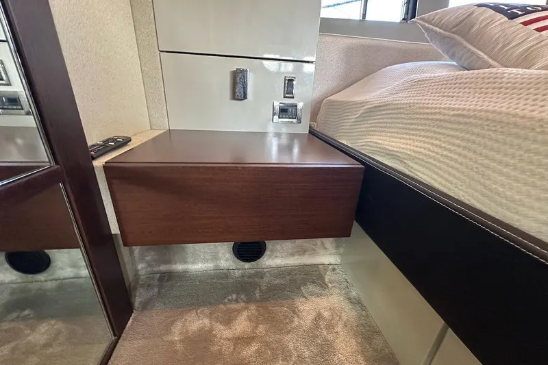 Three Bears Yacht Photos Pics Interior of 2012 Fairline Targa 58 yacht with wooden bedside table and modern design.