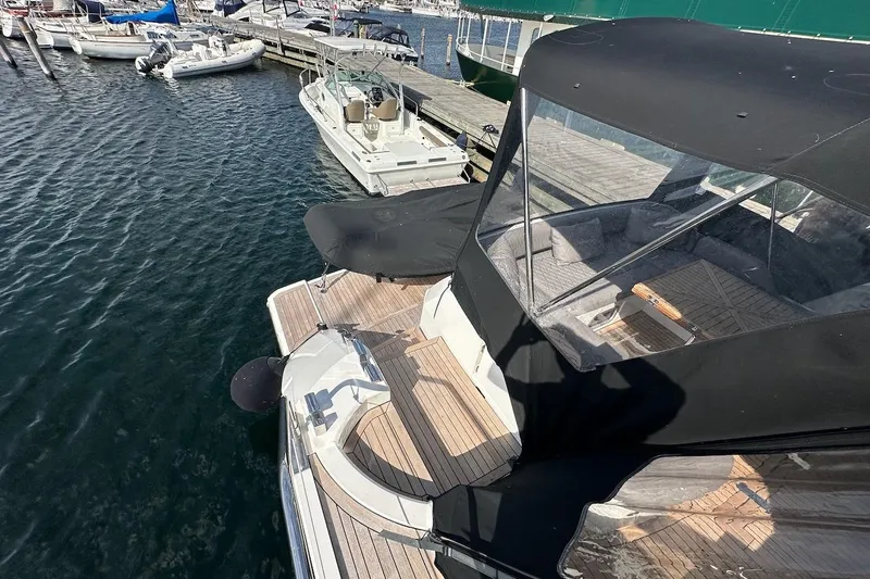 Three Bears Yacht Photos Pics 2012 Fairline Targa 58 yacht docked at marina, featuring sleek design and covered seating area.