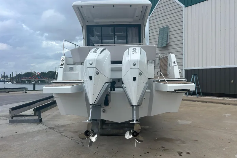  Yacht Photos Pics 2025 Beneteau Antares 11 Coupe with dual outboard engines at dockside.