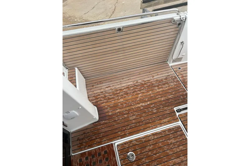  Yacht Photos Pics 2025 Beneteau Antares 11 Coupe deck with sleek wooden finish and modern design.