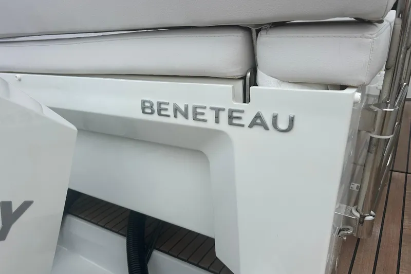  Yacht Photos Pics 2025 Beneteau Antares 11 Coupe boat detail with logo and seating.