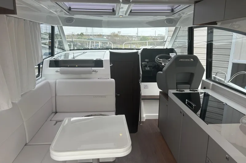  Yacht Photos Pics Interior of 2025 Beneteau Antares 11 Coupe, featuring modern helm and seating area.