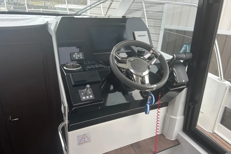  Yacht Photos Pics 2025 Beneteau Antares 11 Coupe helm with modern steering and control panel.