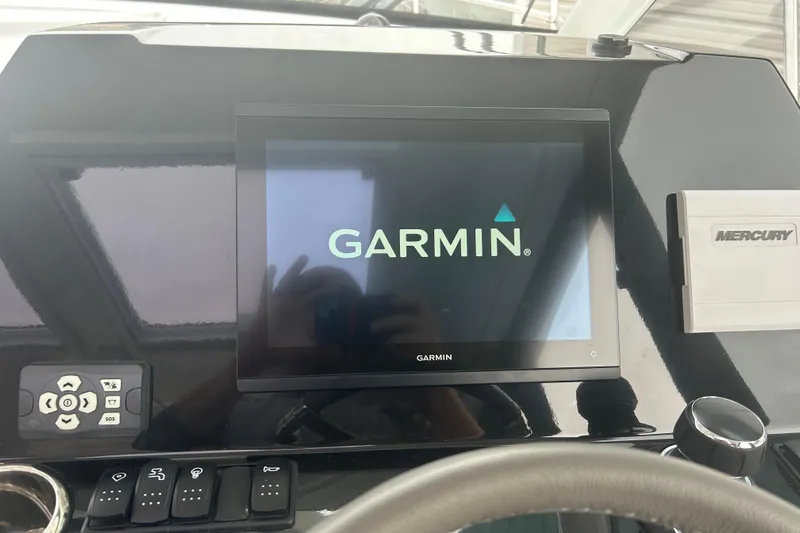  Yacht Photos Pics Garmin display on 2025 Beneteau Antares 11 Coupe dashboard with Mercury controls.