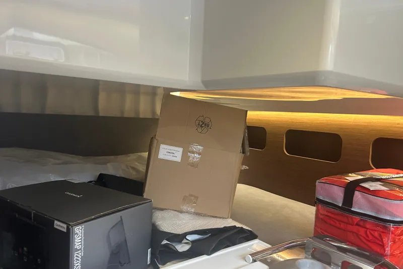  Yacht Photos Pics Interior of 2025 Beneteau Antares 11 Coupe with boxes and equipment.