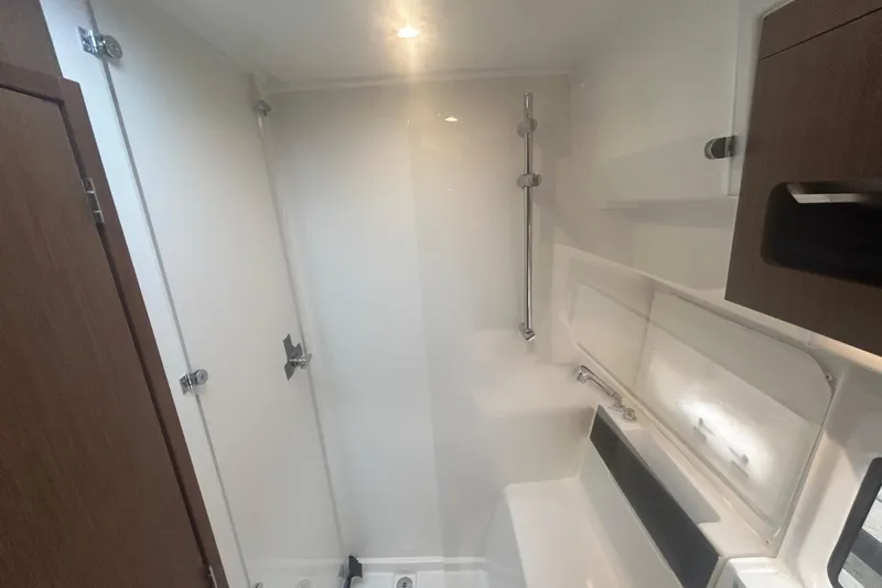  Yacht Photos Pics Bathroom interior of 2025 Beneteau Antares 11 Coupe, featuring modern fixtures and wood accents.