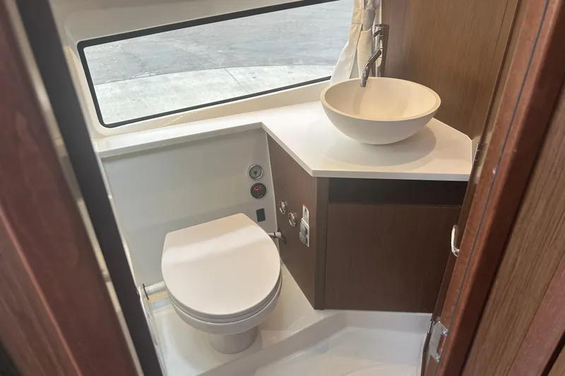  Yacht Photos Pics Modern bathroom in 2025 Beneteau Antares 11 Coupe with sleek sink and toilet.