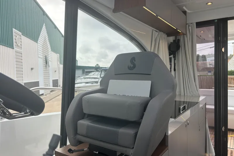  Yacht Photos Pics 2025 Beneteau Antares 11 Coupe interior with modern helm seat and sleek design.