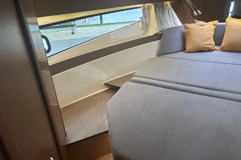  Yacht Photos Pics Interior of 2025 Beneteau Antares 11 Coupe with cozy seating and cushions.