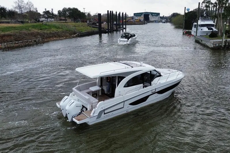  Yacht Photos Pics 2026 Beneteau Antares 11 Coupe cruising on a scenic river.