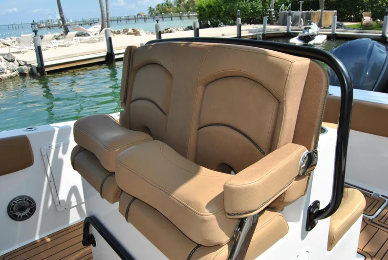  Yacht Photos Pics 2020 Sea Hunt Gamefish 30 boat seating with tan upholstery, docked by the water.